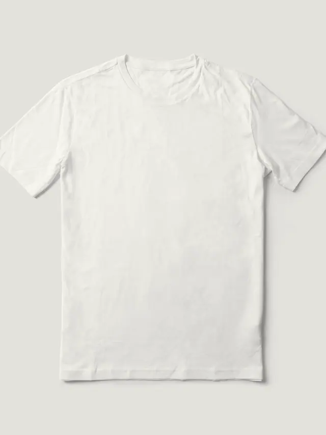 The Box Tee in undyed white loopback cotton jersey, laid flat on grey pattern paper.
