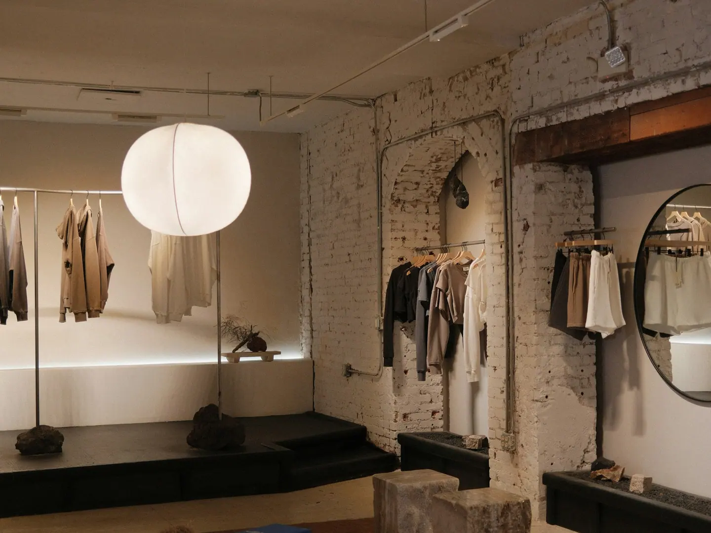 The far end of the room: brick, a long bench and the second rail.