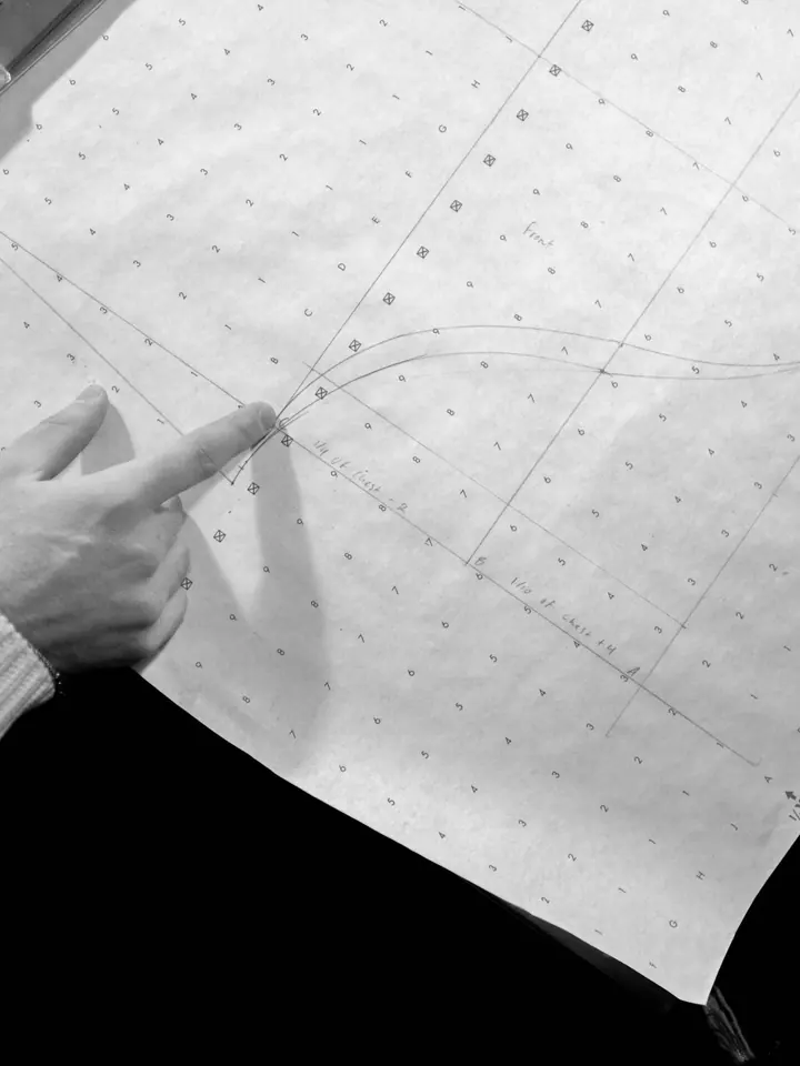 A pattern marked out in pencil on spot-and-cross paper.