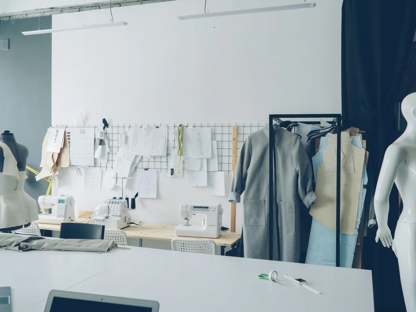 The workroom: machines along the window, patterns pinned to the wall.