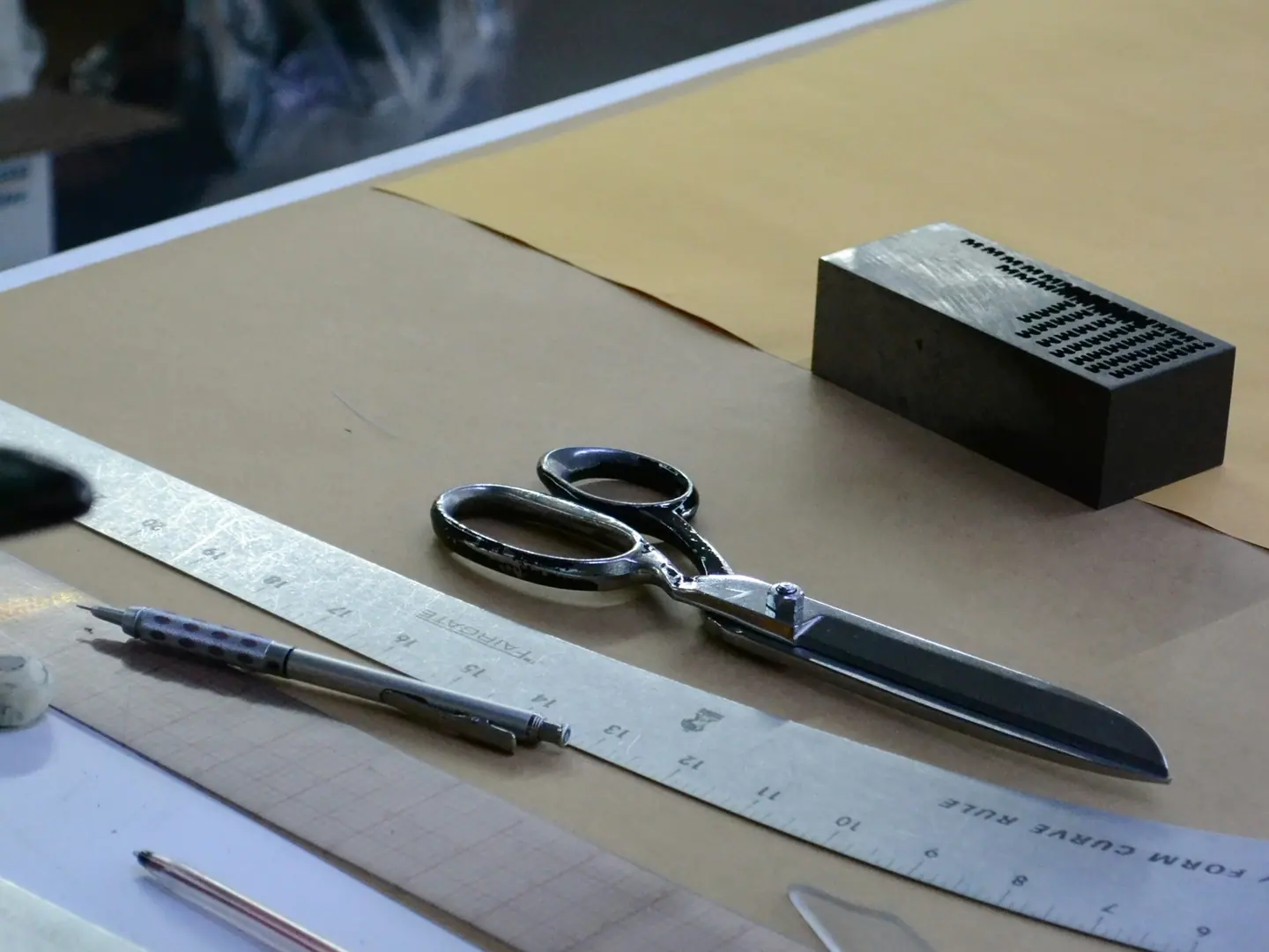 The cutting table: shears, a metre rule and a marked pattern.