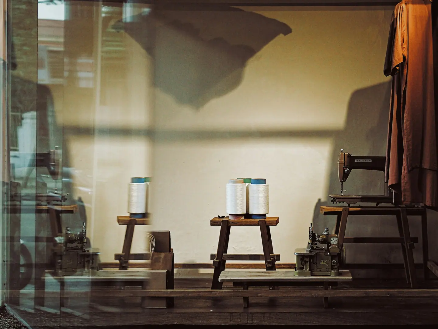 Thread and a machine at the workroom window, first thing.