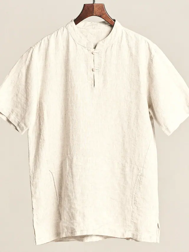 The Popover in undyed washed linen, laid flat on grey pattern paper.