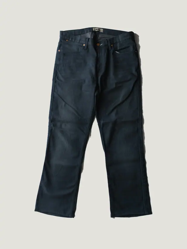 The Wide Trouser in indigo heavy cotton twill, laid flat on grey pattern paper.